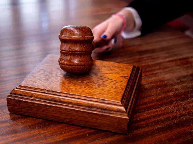 Wooden judge gavel on a courtroom desk