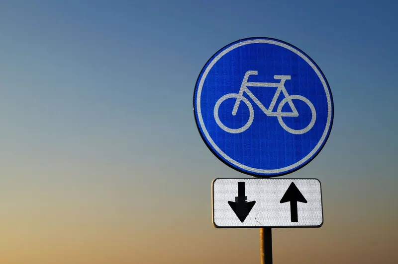 Direction sign with arrows at dusk