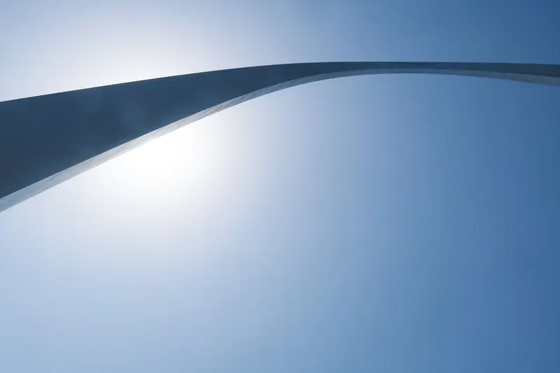 The Gateway Arch in St. Louis against a blue sky