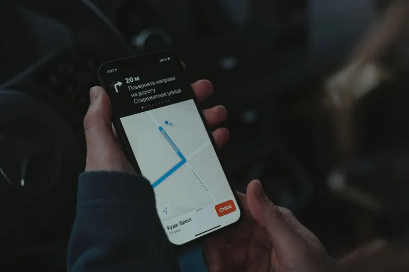 Smartphone displaying a navigation map inside a car