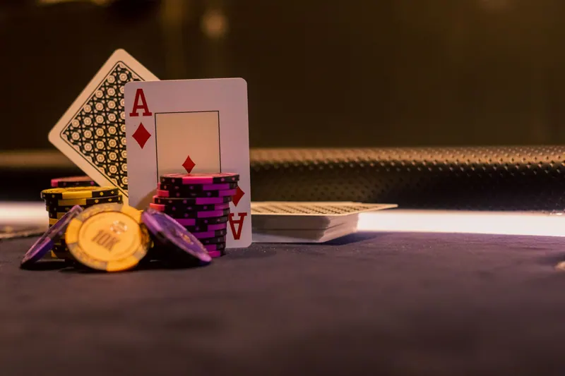 Poker chips and playing cards on a casino gaming table
