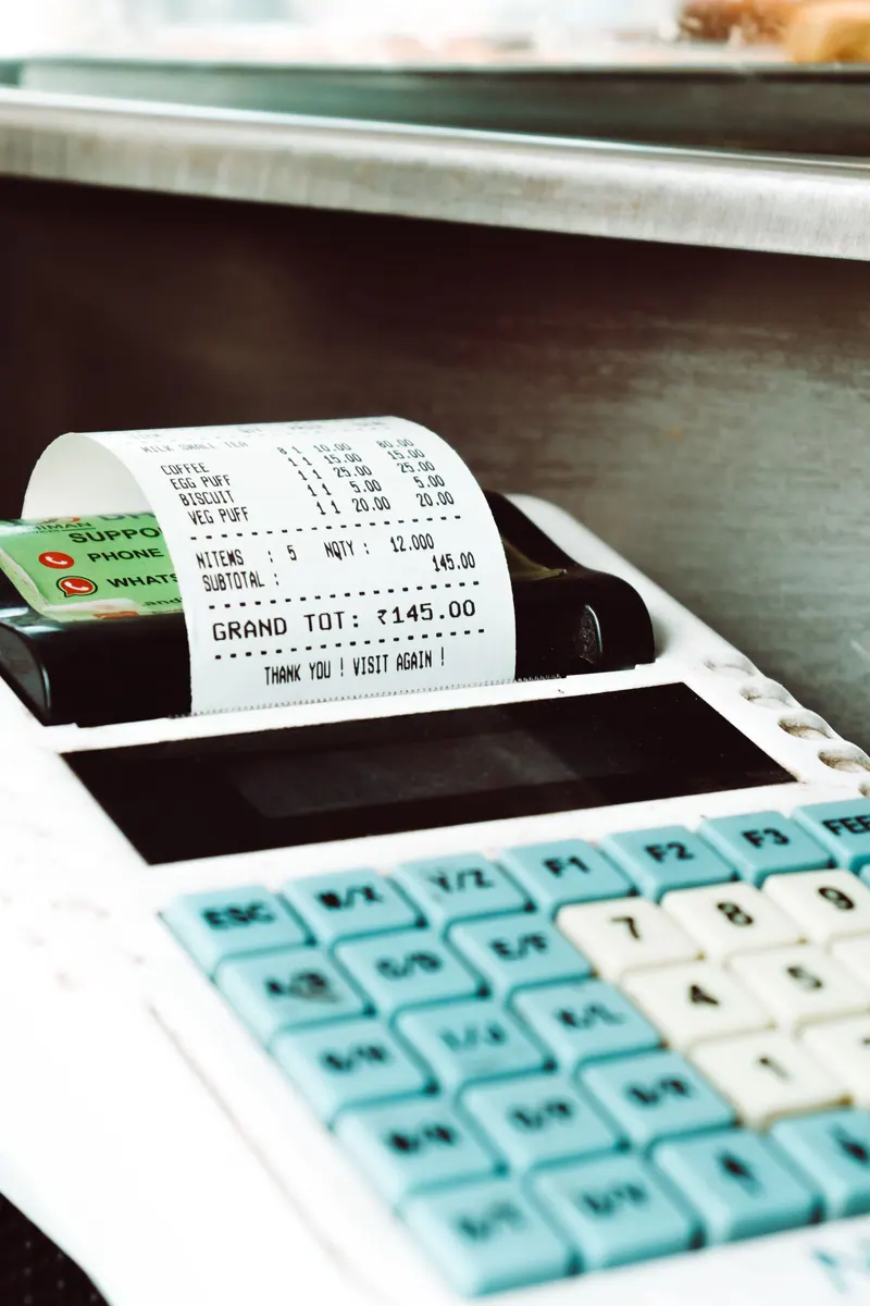 Close-up of a cash register printing a receipt in a retail store