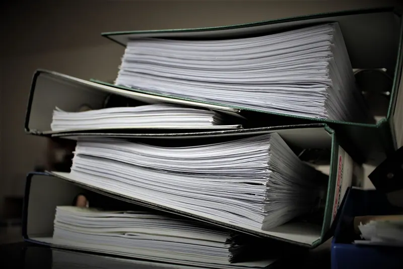 Thick binders filled with paper records