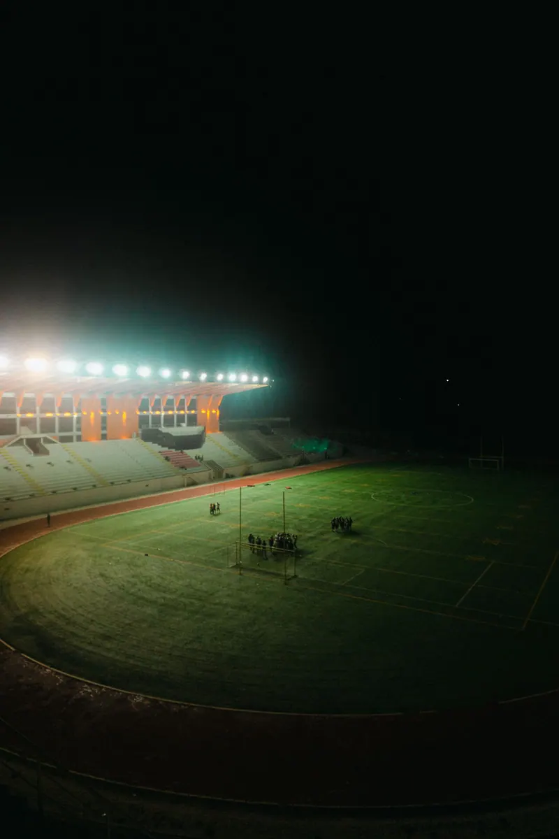Aerial view of an illuminated sports stadium at night
